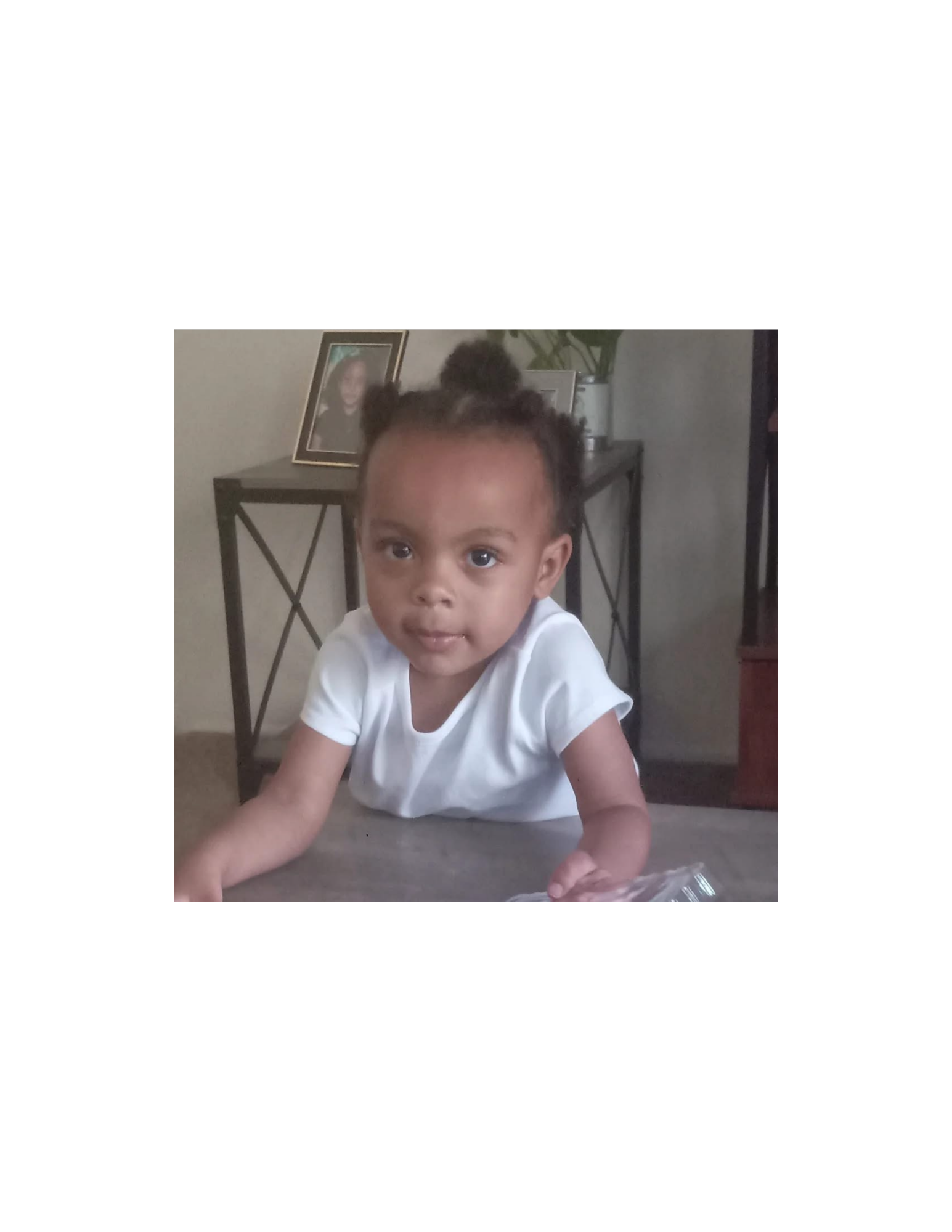 Jazzie as a little girl in a white shirt