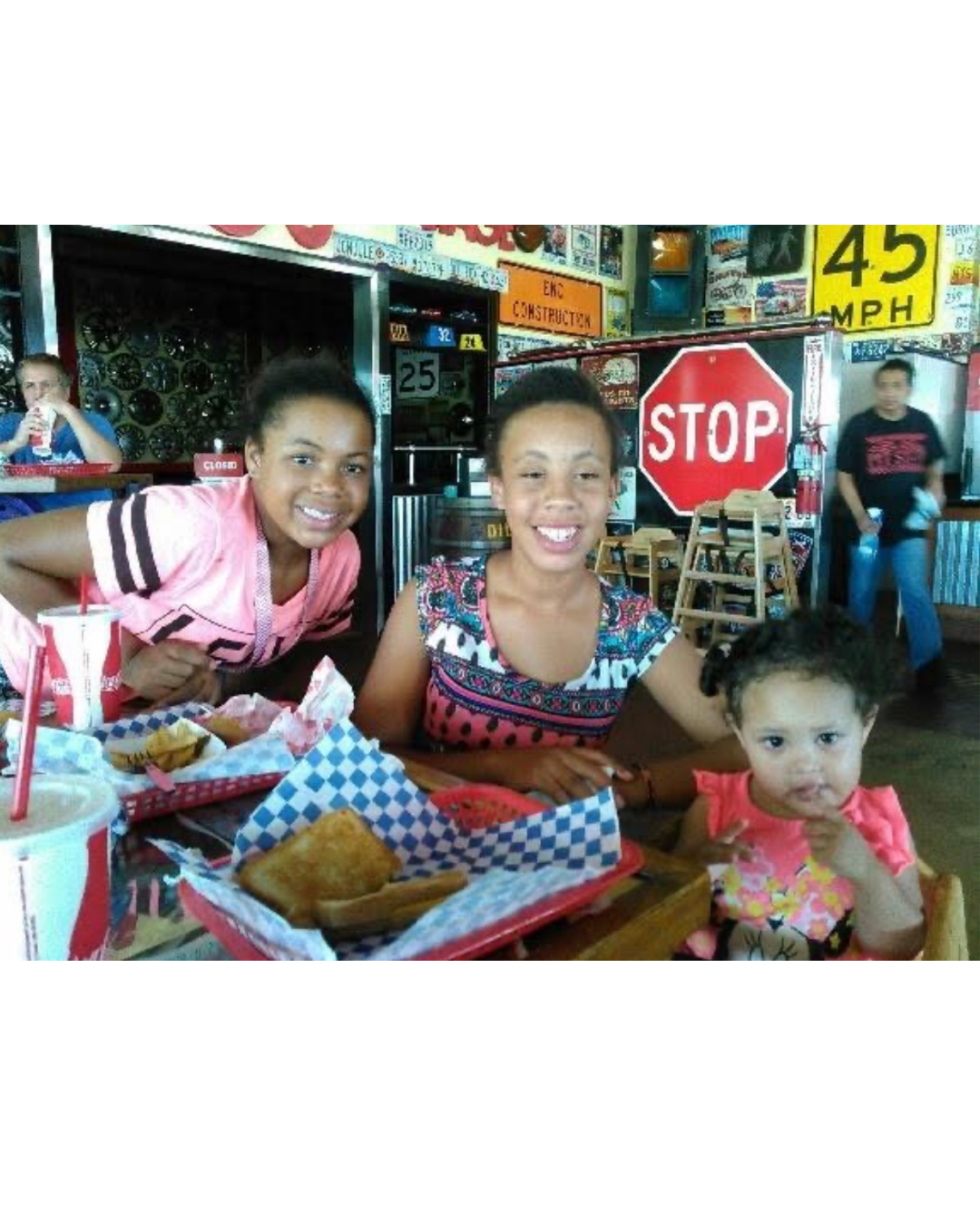 Jazzie with sisters at a diner