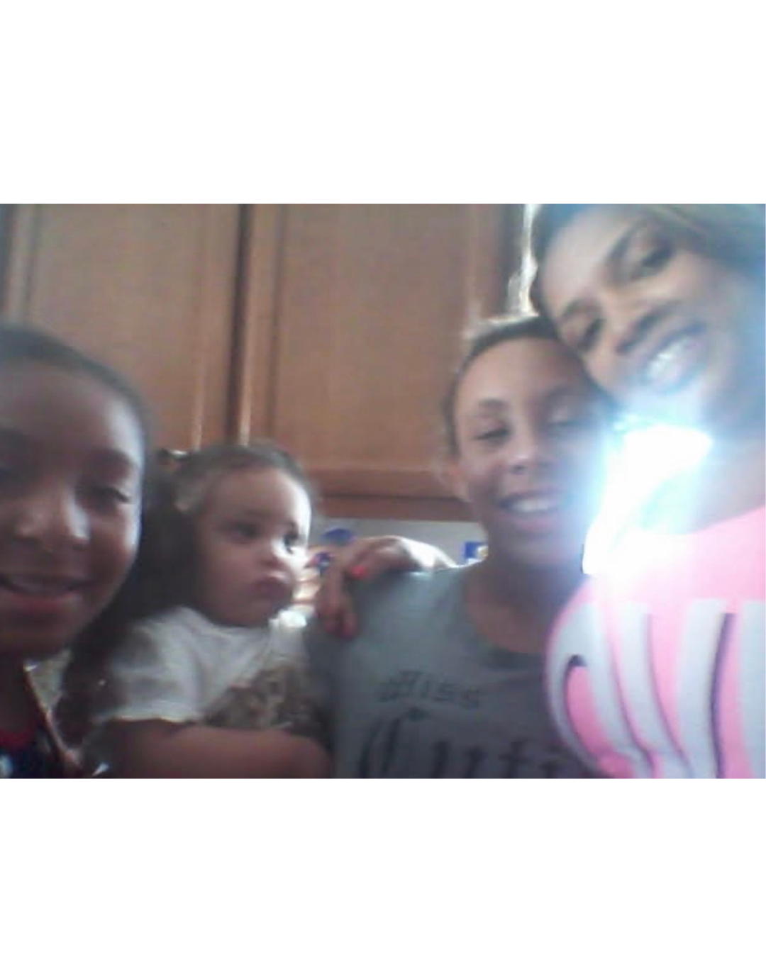 Jazzie with siblings in the kitchen